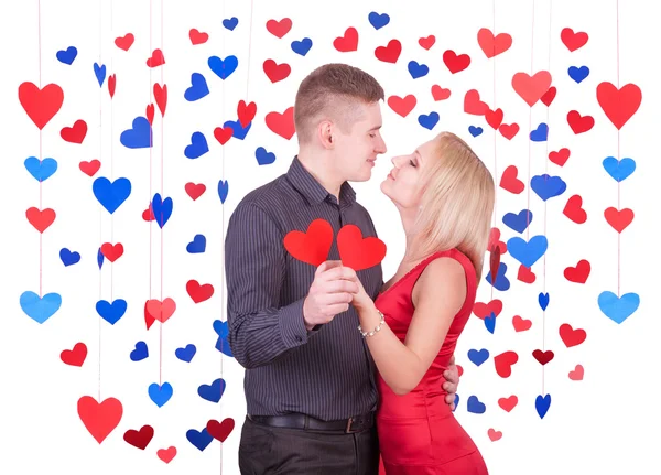 Loving couple in many heart shapes — Stock Photo, Image