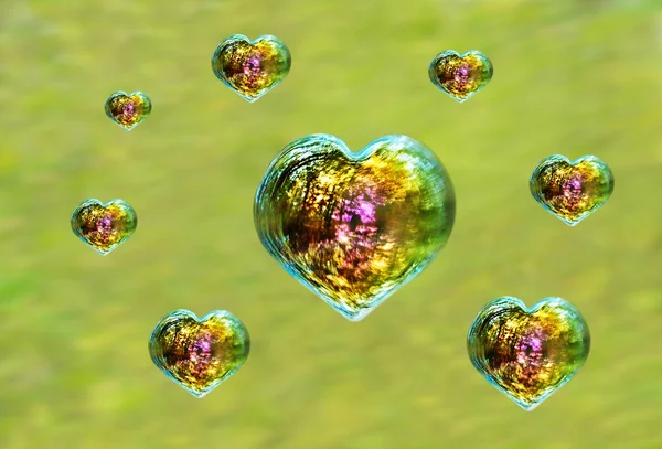 Many heart shaped iridescent soap bubbles — Stock Photo, Image