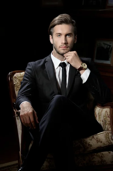 Portrait of sexy macho man over dark background wearing a chronograph wrist watch — Stock Photo, Image