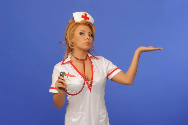 Sexual woman in nurse suit with stethoscope blue backgroun — Stock Photo, Image