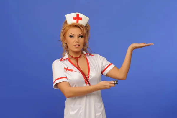 Sexual woman in nurse suit with stethoscope blue backgroun — Stock Photo, Image