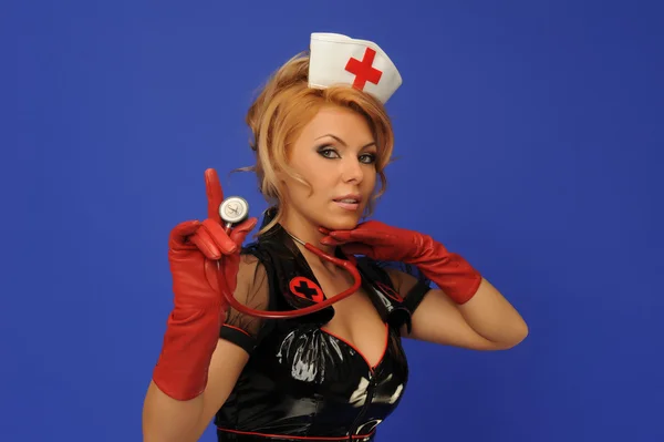 Kobieta w pielęgniarka garnitur z stetoskop niebieski deseń — Zdjęcie stockowe