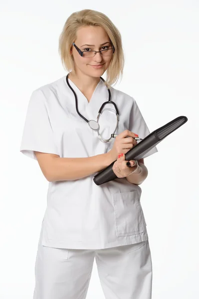 Beautiful nurse smiling and taking notes on a white isolated backgroun — Stock Photo, Image