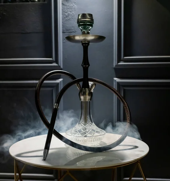 Smoke luxury hookah in lounge bar.