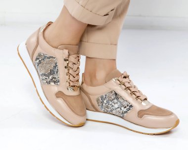 Beyaz bir iç mekanda bej renkli şık ayakkabılar. Mevsimin modası ve reklam fotoğrafları