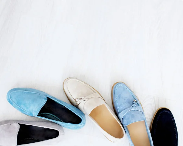 Stylish suede light blue, white and blue loafers stand in a row. Fashionable and stylish shoes and beautiful shoes.