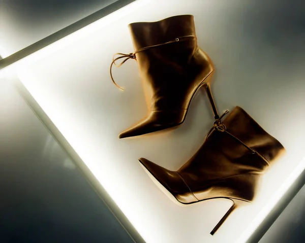 Brown stylish ankle boots in a white interior. Trend of the season and photos for advertising