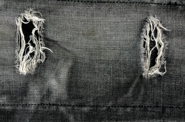 Detail of torn Black denim, front view jean — Stock Photo, Image