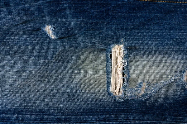 Detail of torn Blue denim, front view jean — Stock Photo, Image