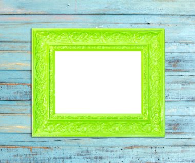 Mavi ahşap zemin üzerine yeşil vintage fotoğraf çerçevesi