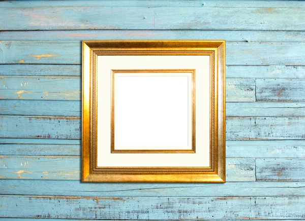 Gold Vintage picture frame on blue wood background — Stock Photo, Image