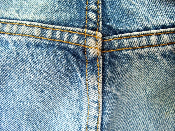 กางเกงยีนส์วินเทจที่มีพื้นหลังตะเข็บ — ภาพถ่ายสต็อก