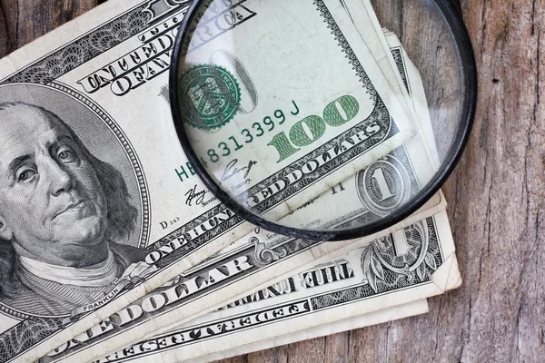 Magnifying glass on american dollars — Stock Photo, Image