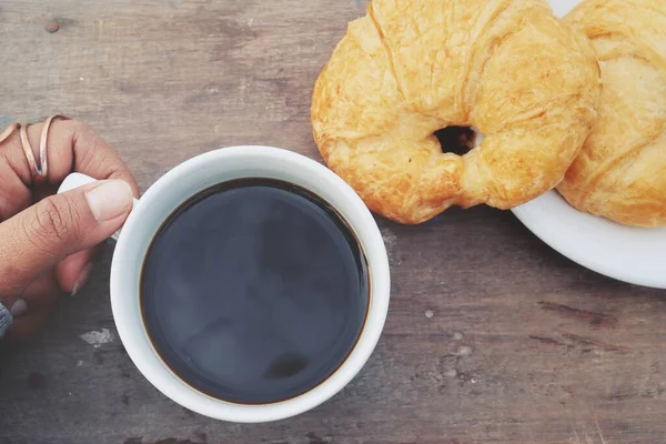 Croissant Bakery Hand Black Coffee Wood Background — Φωτογραφία Αρχείου