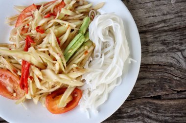 Papaya salatası ahşap arka plan üzerinde Tayland Gıda