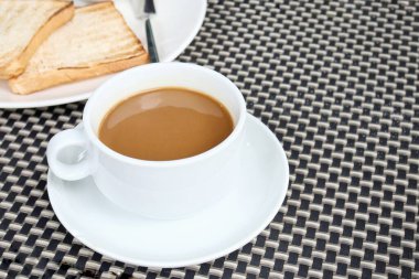 Sıcak kahve fincanı ve kızarmış ekmek kahvaltısı.