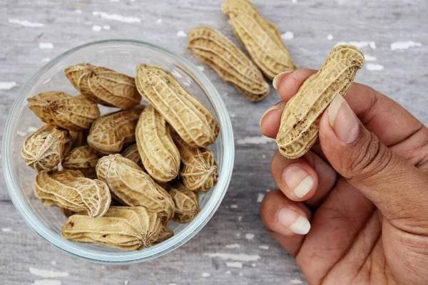 Peanut Hand Old White Wood Background — Zdjęcie stockowe