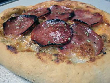 Bake homemade pizza hot from oven.