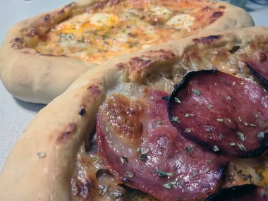 Bake homemade pizza hot from oven.