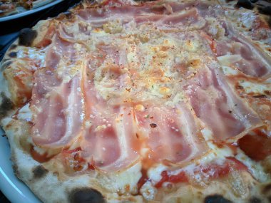 Bake homemade pizza hot from oven.