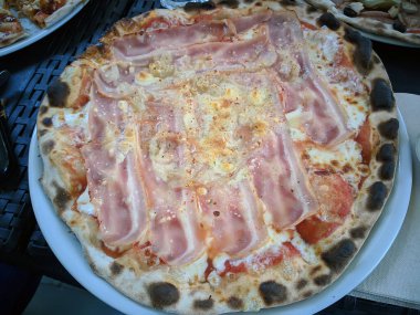 Bake homemade pizza hot from oven.