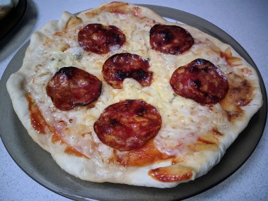 Bake homemade pizza hot from oven.