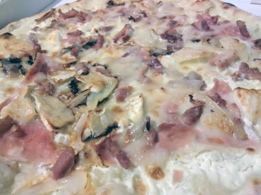 Bake homemade pizza hot from oven.