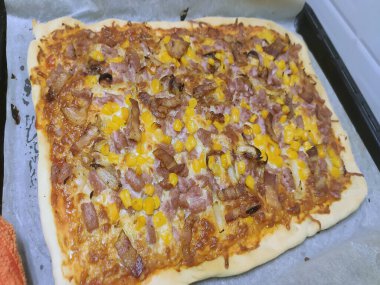 Bake homemade pizza hot from oven.
