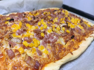 Bake homemade pizza hot from oven.