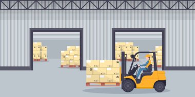 Industrial warehouse for the storage products and racks with stacked boxes. Worker driving forklift loading pallets. Industrial storage and distribution of products