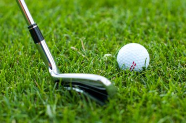 Yeşil bir çayırda golf topu tasviri