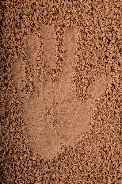 Hand in sand on beach — Stock Photo, Image