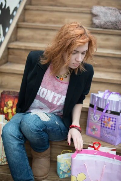 Beautiful girl sitting on wooden stairs — Stock Photo, Image