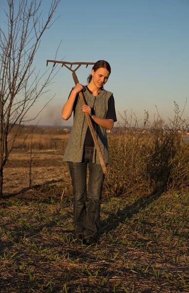 Girl on field work the land at sunset — Stock Photo, Image