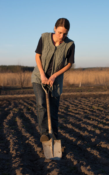 girl on field work the land at sunset