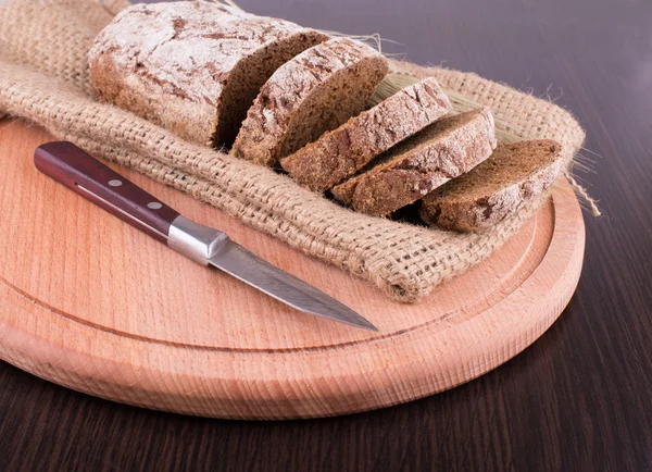 Dunkles Brot auf dem Holzbrett — Stockfoto