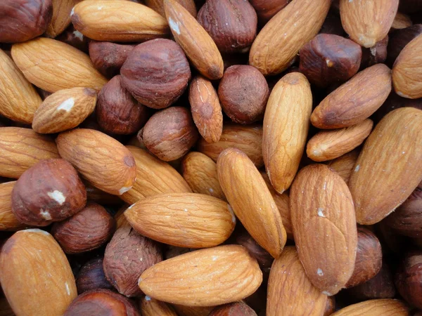 Hazelnuts and almonds background — Stock Photo, Image