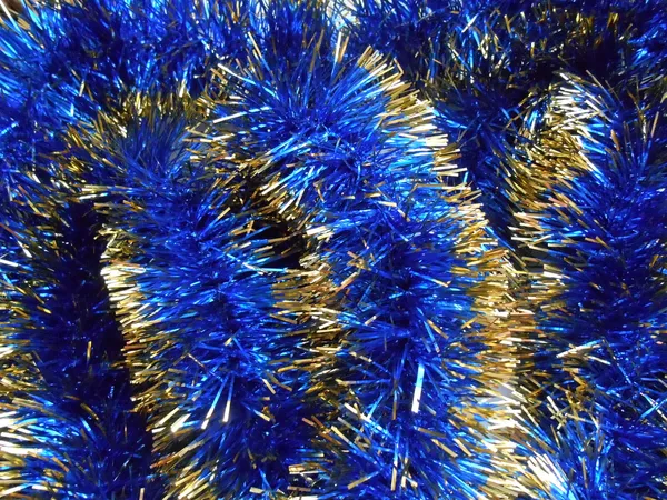 Christmas and New Year blue and gold tinsel background — Stock Photo, Image