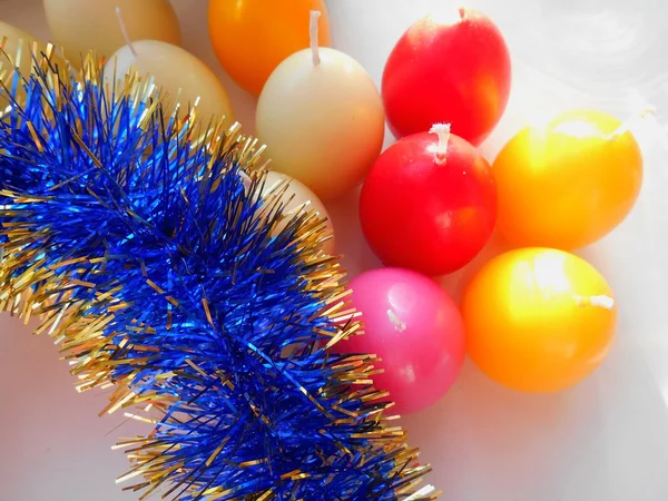 Christmas and New Year candles and tinsel on white background — Stock Photo, Image