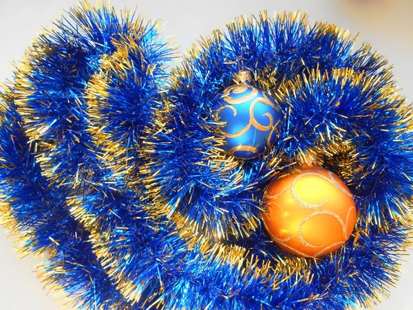 Christmas and New Year balls blue and gold tinsel abstract background — Stock Photo, Image