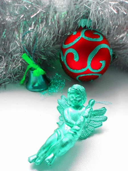 Christmas decoration angel and balls on a tinsel abstract background — Stock Photo, Image