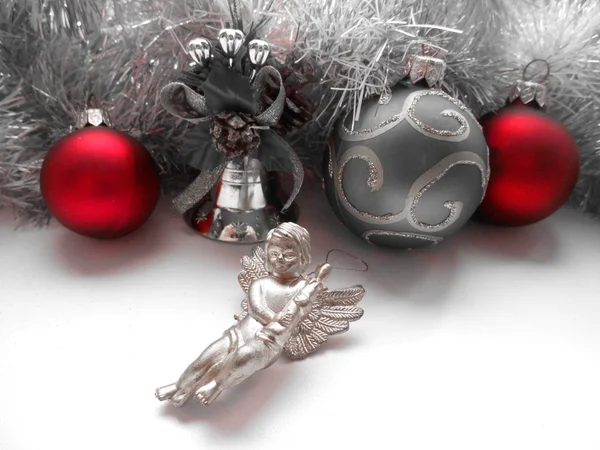 Christmas decoration angel and balls on a tinsel background — Stock Photo, Image