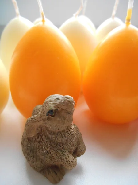 Rabbit on the background candle eggs — Stock Photo, Image