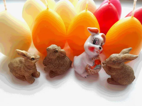 Rabbits on the background candle eggs — Stock Photo, Image