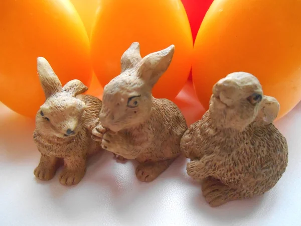 Rabbits on the background candle eggs — Stock Photo, Image