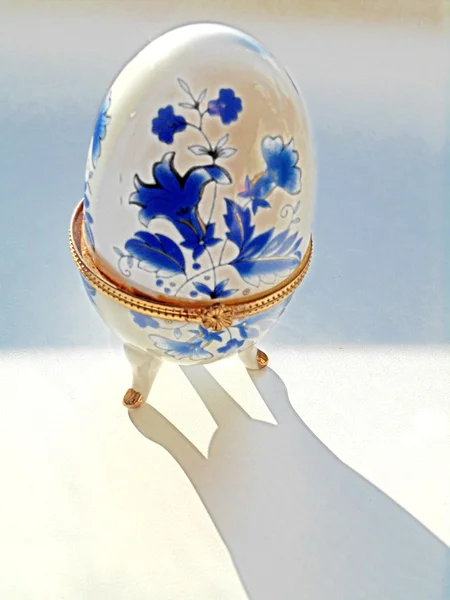 Porcelain egg on a white background — Stock Photo, Image