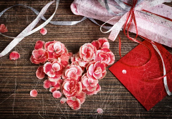 Vintage heart from flowers on wooden table — Stock Photo, Image