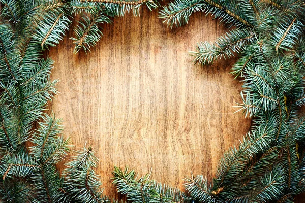 Christmas fir tree on a wooden board — Stock Photo, Image