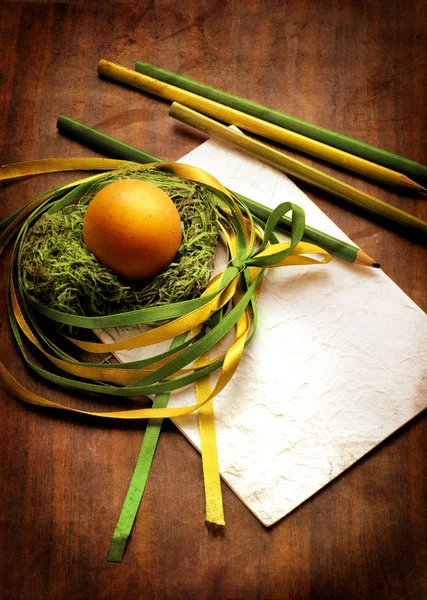 Easter egg with colorfull ribbon as a nest — Stock Photo, Image