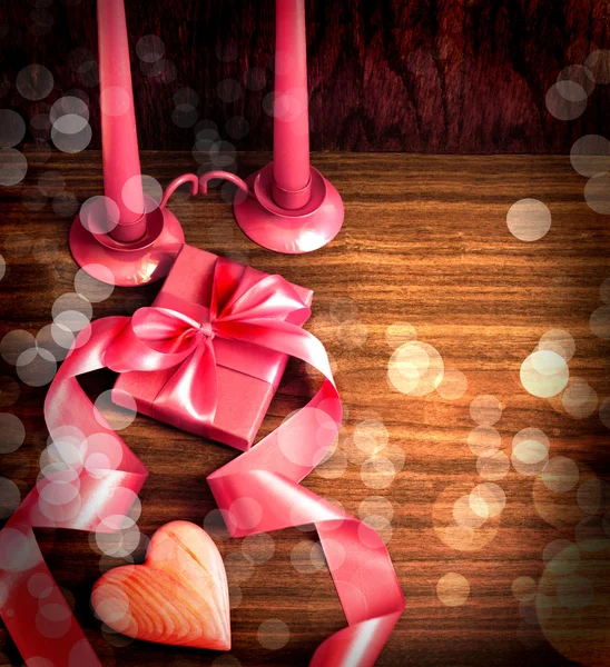 Valentines Day background with heart and holidays gift on old wooden background with two candle. — Stock Photo, Image